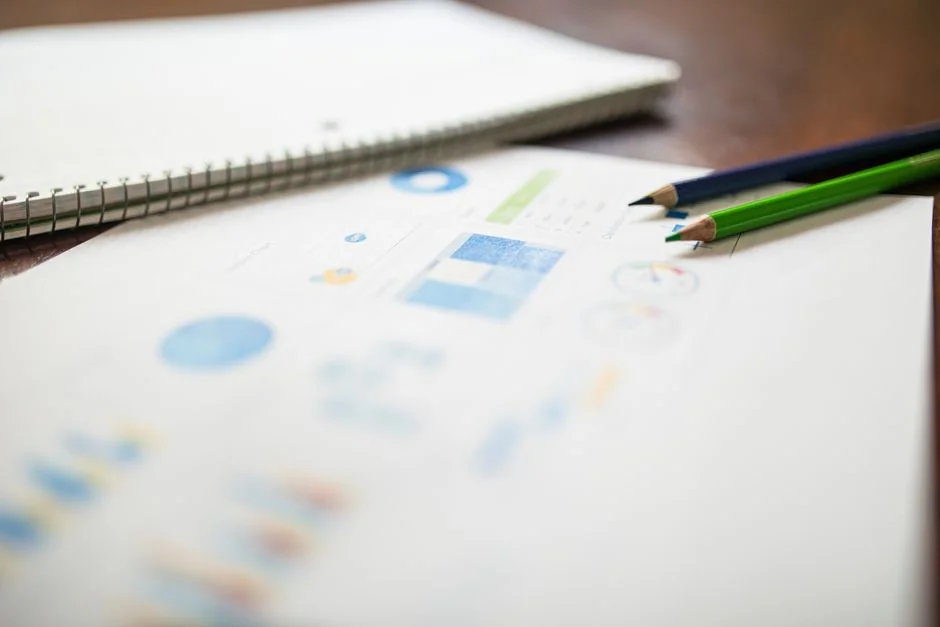 Close-up of a woman working on a digital marketing project in a home office setting.